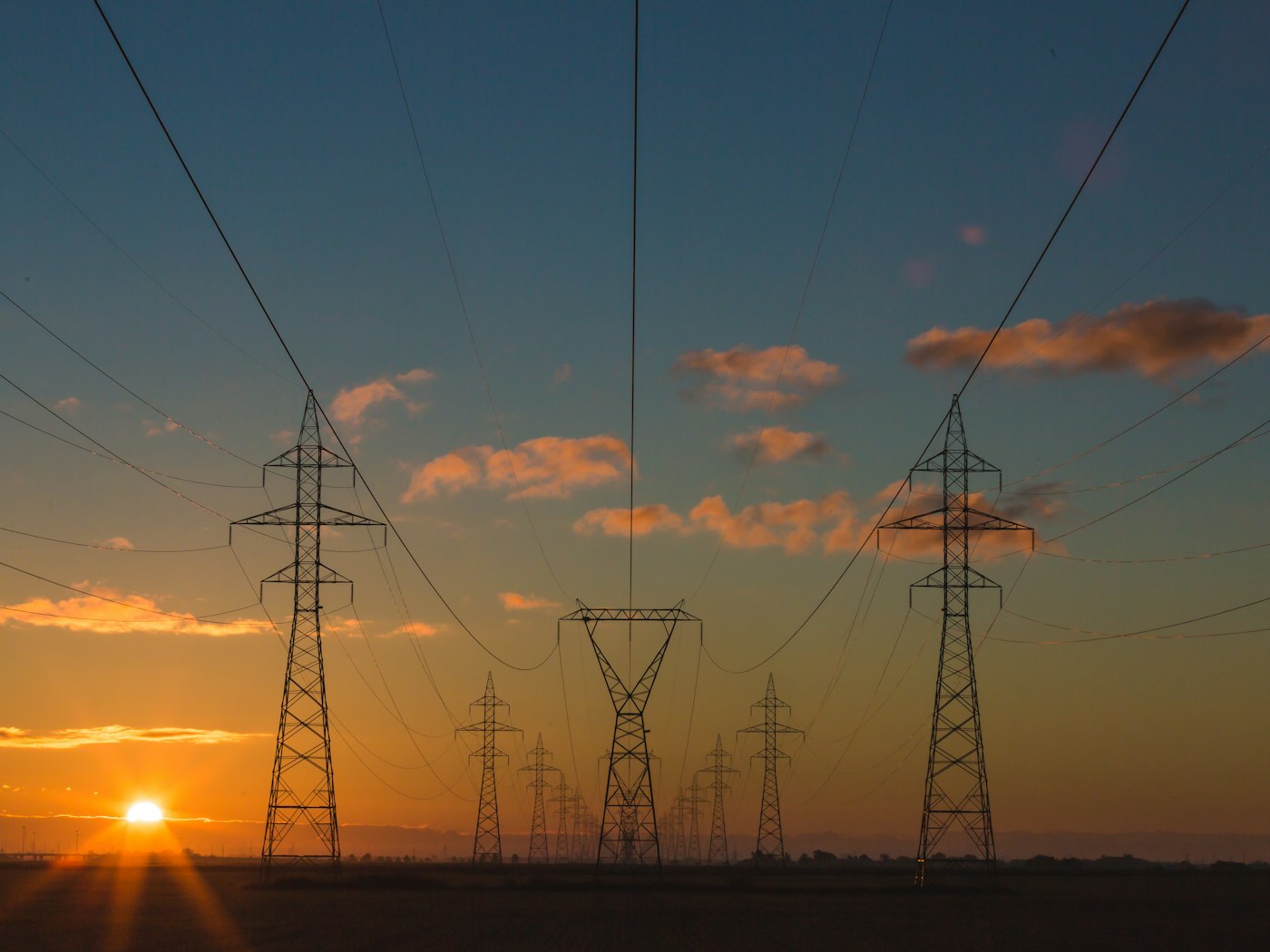 High-voltage power lines at dusk